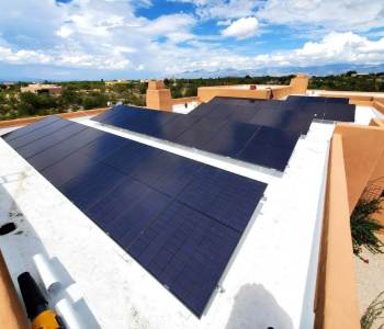 Black-Solar-Panels-on-a-White-Roof-Image